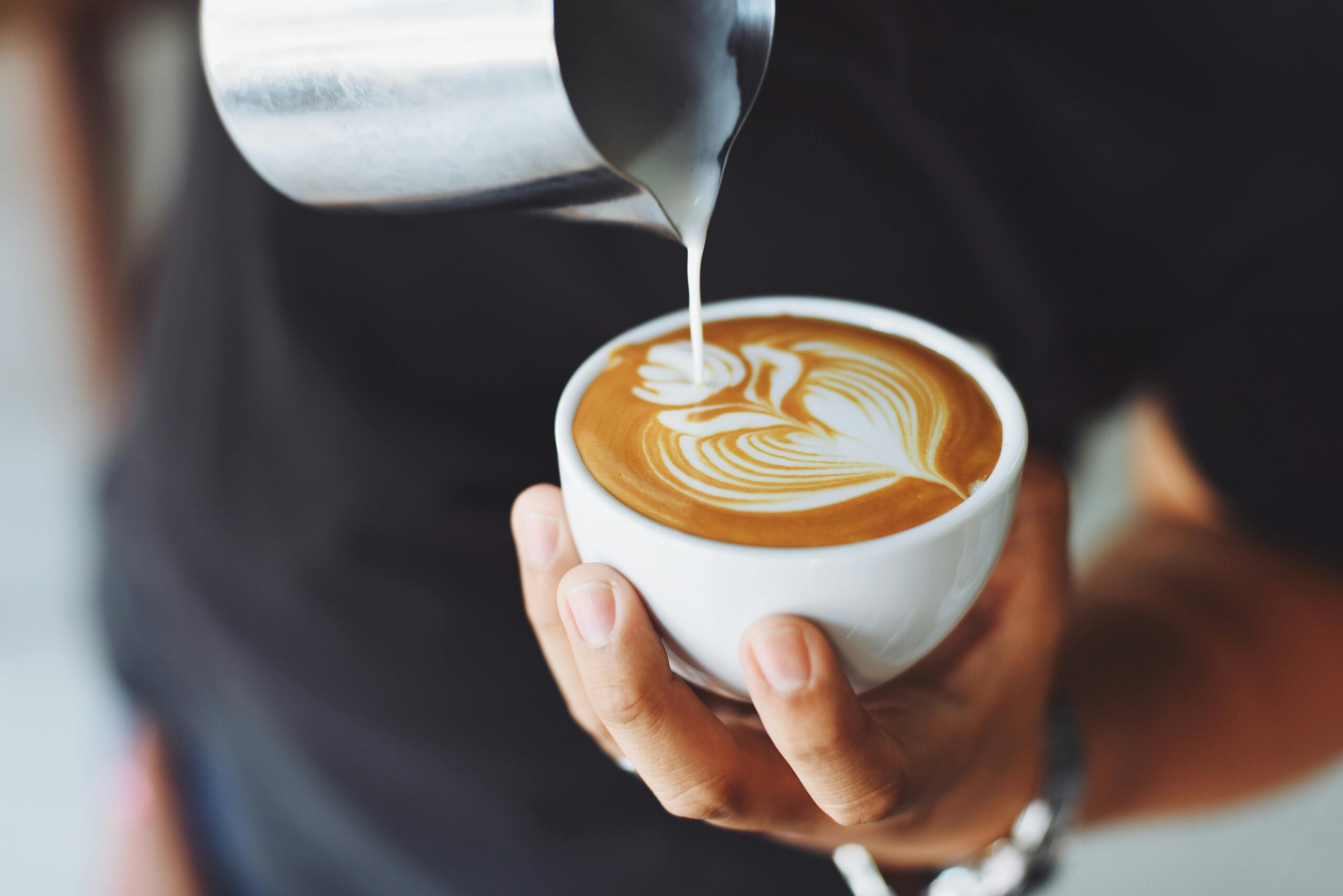 Barista pouring a latte