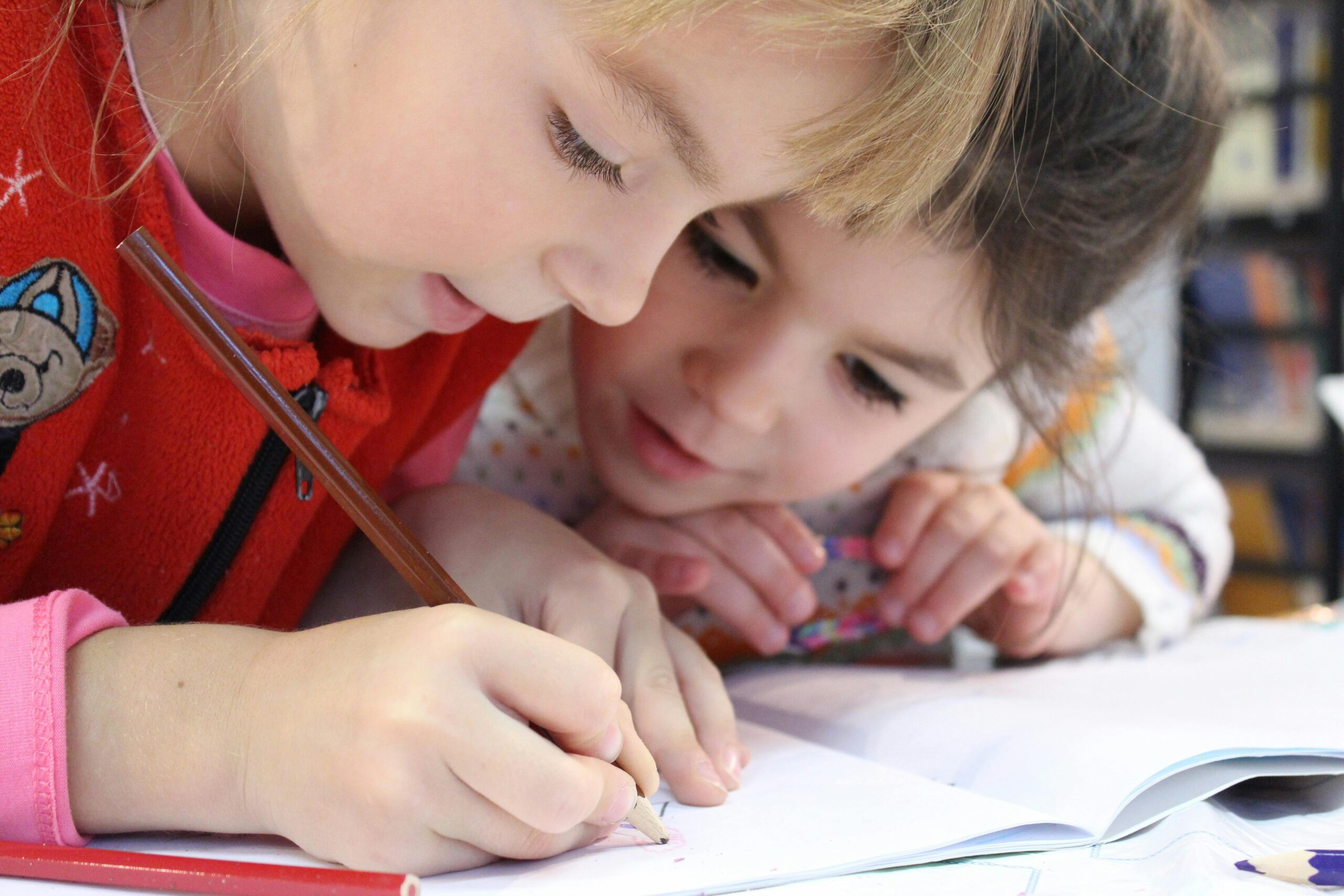 Two young kids doing school work at a desk