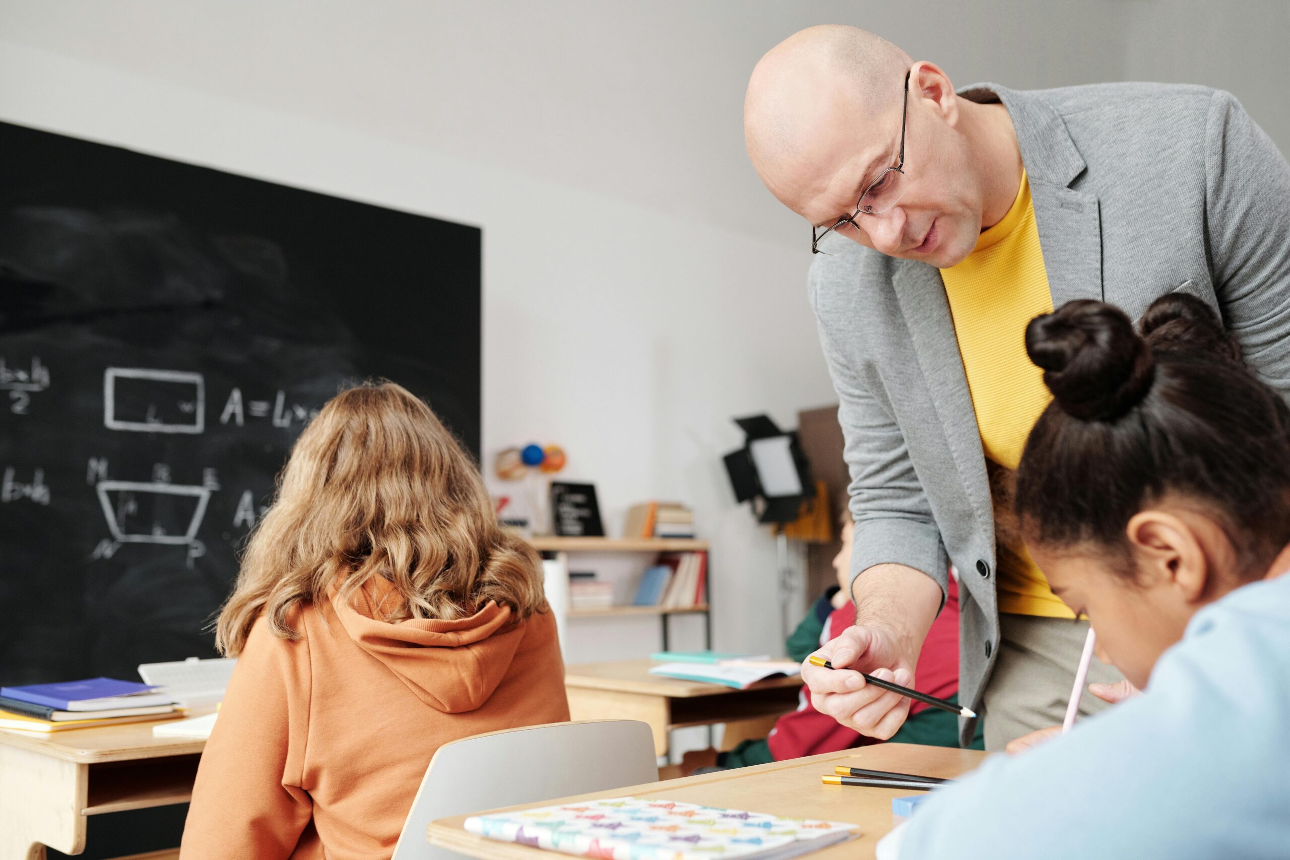 Teacher helping a student in classroom
