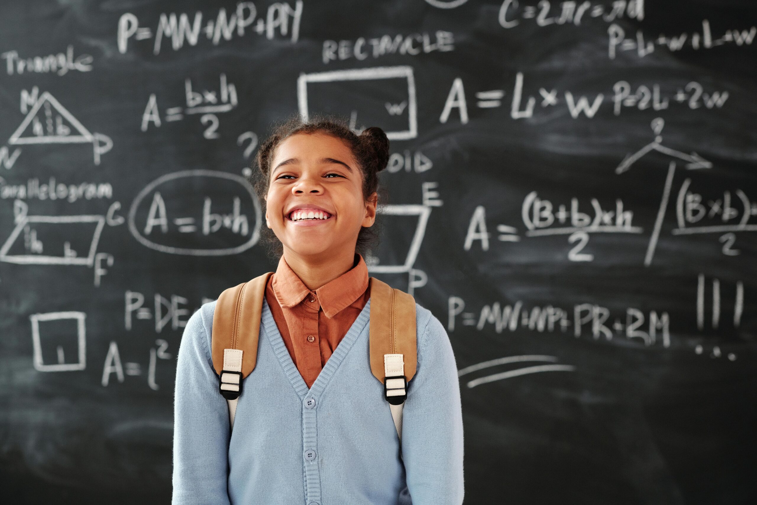 Student in front of a chalk board