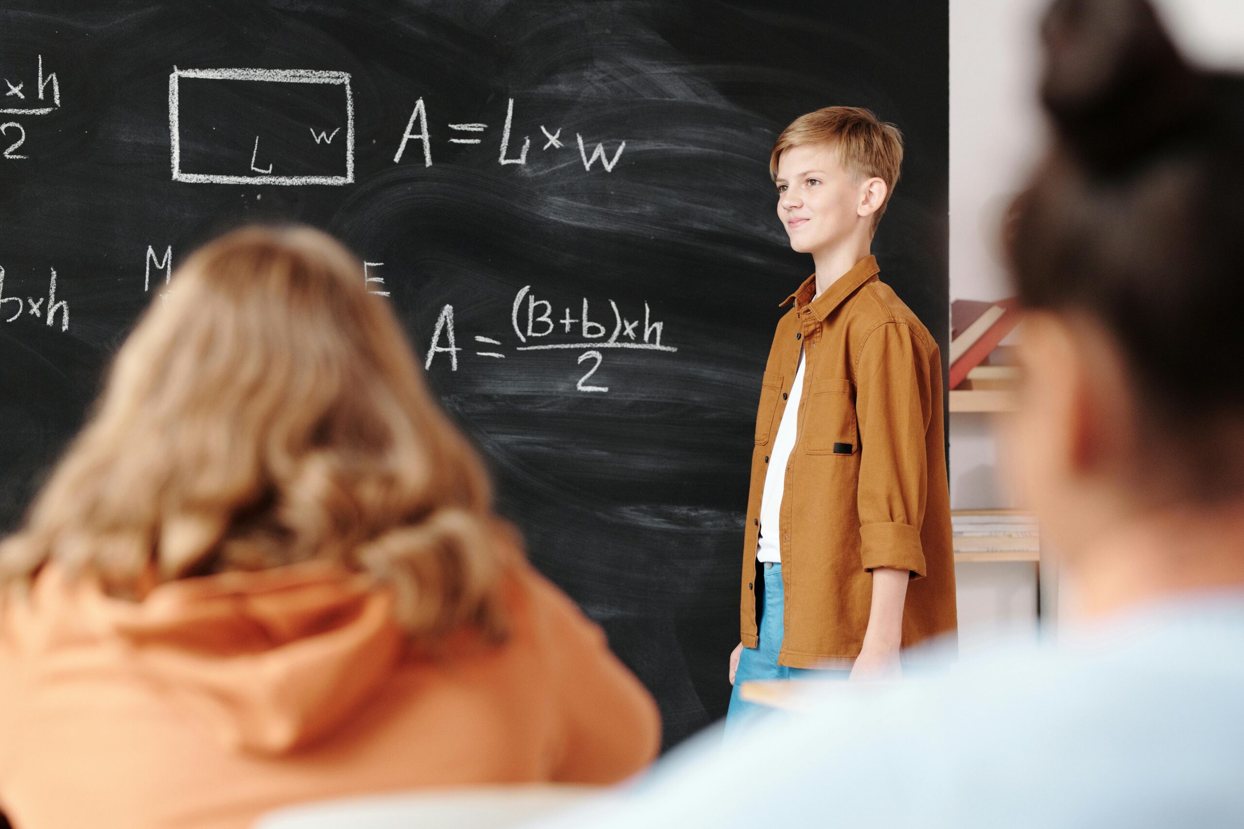 Student at the board in front of classmates.