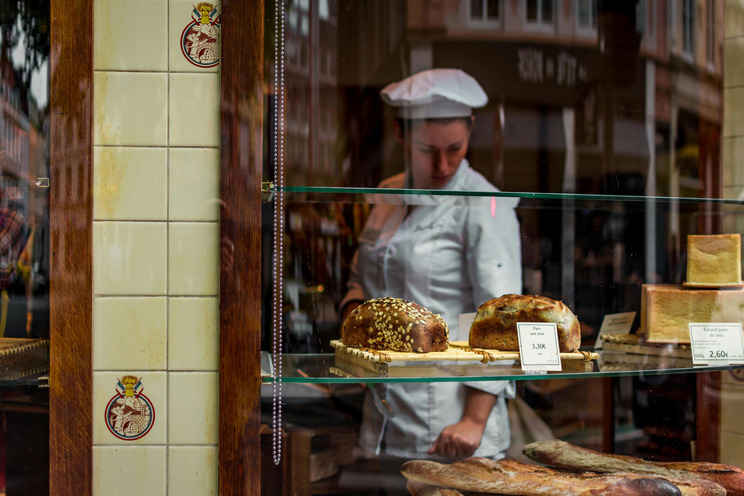 Baker in a pastry window.