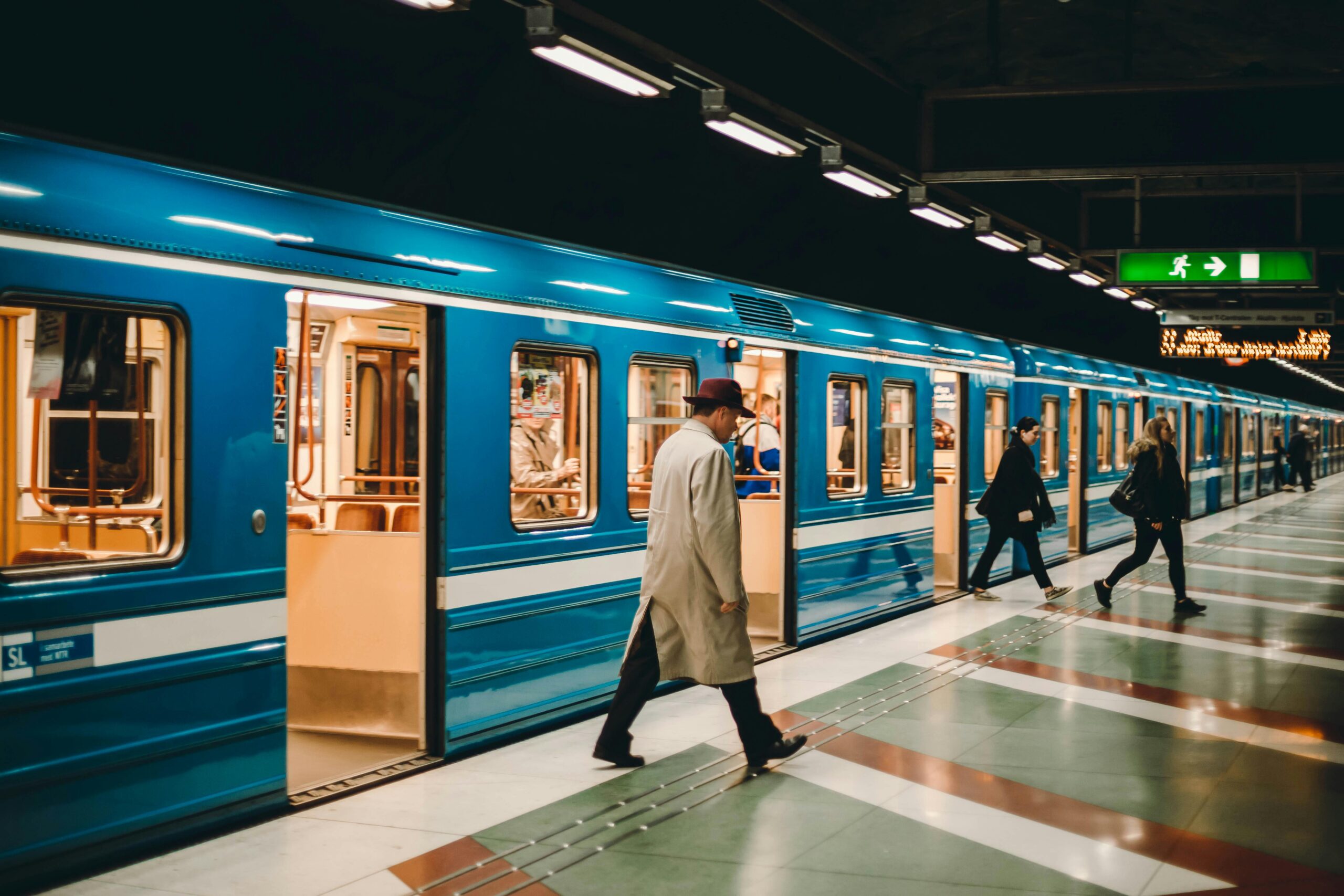 A man walking out of a subway train.