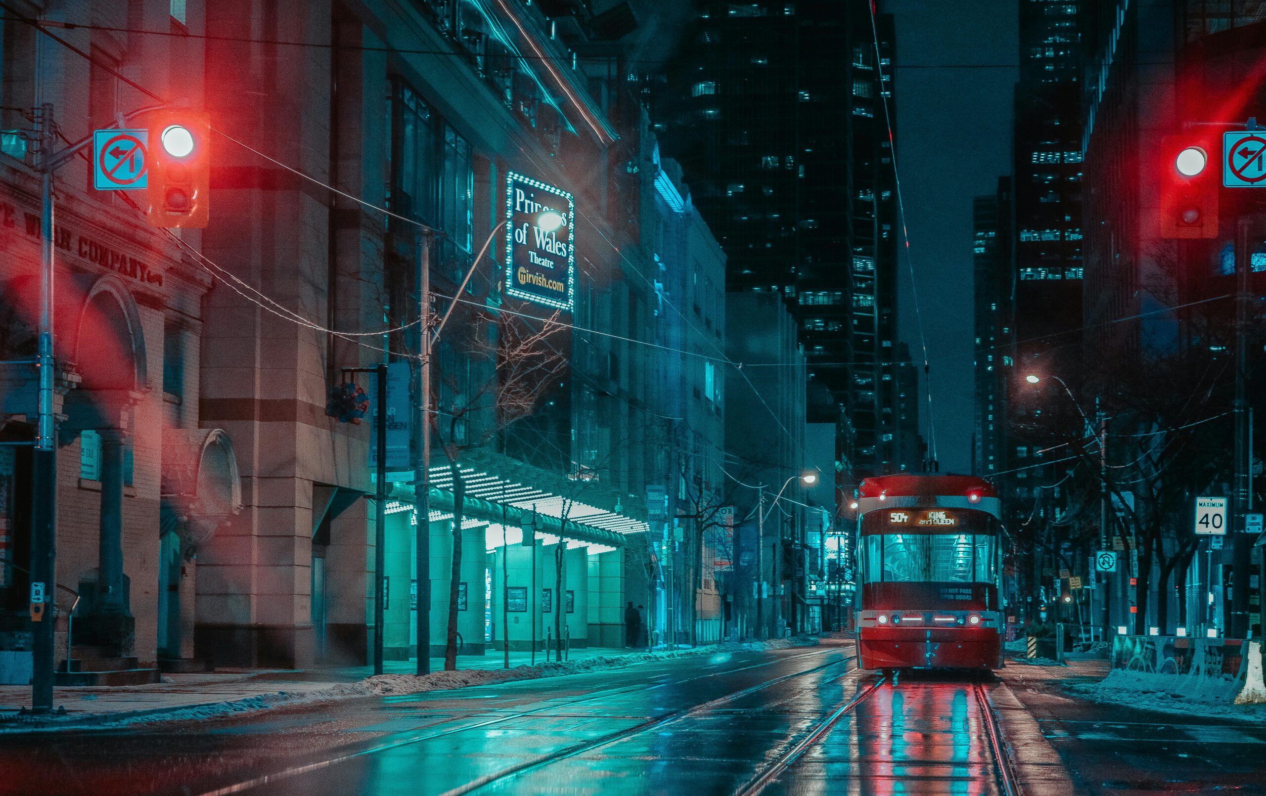 Toronto transit car at night with light reflections.