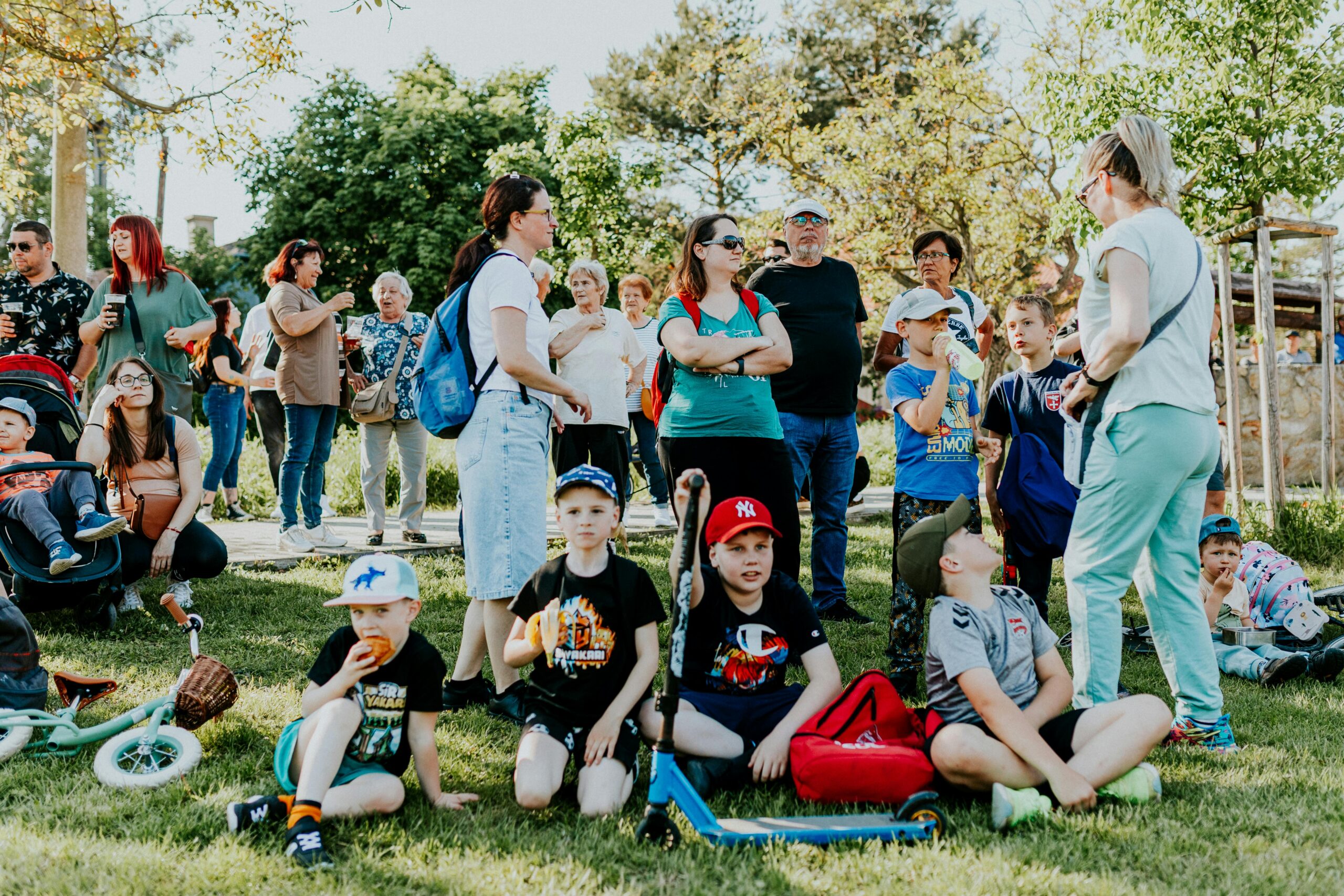 A community gathering outside in a park.