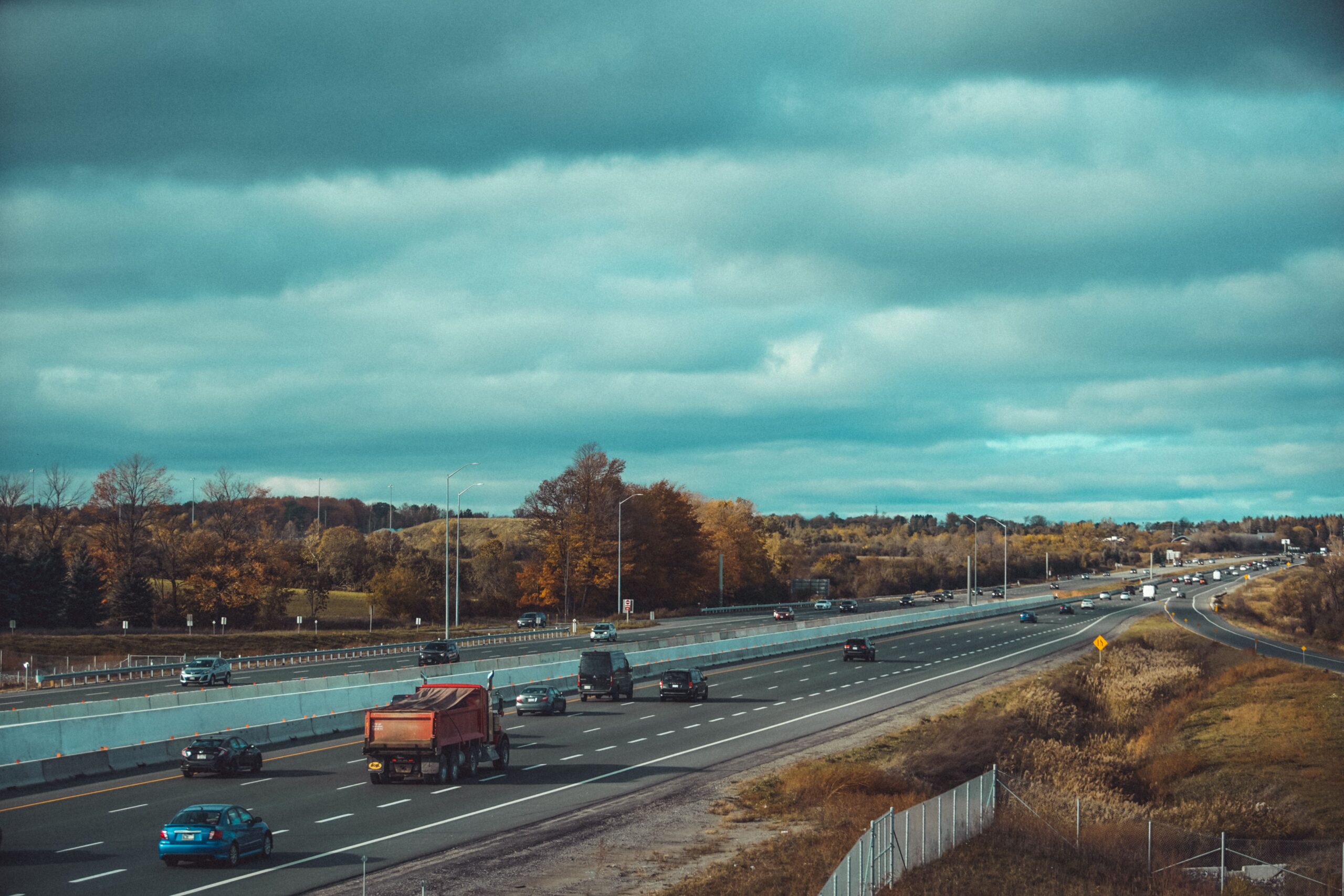 Highway view in the city with cars with overcast clouds,