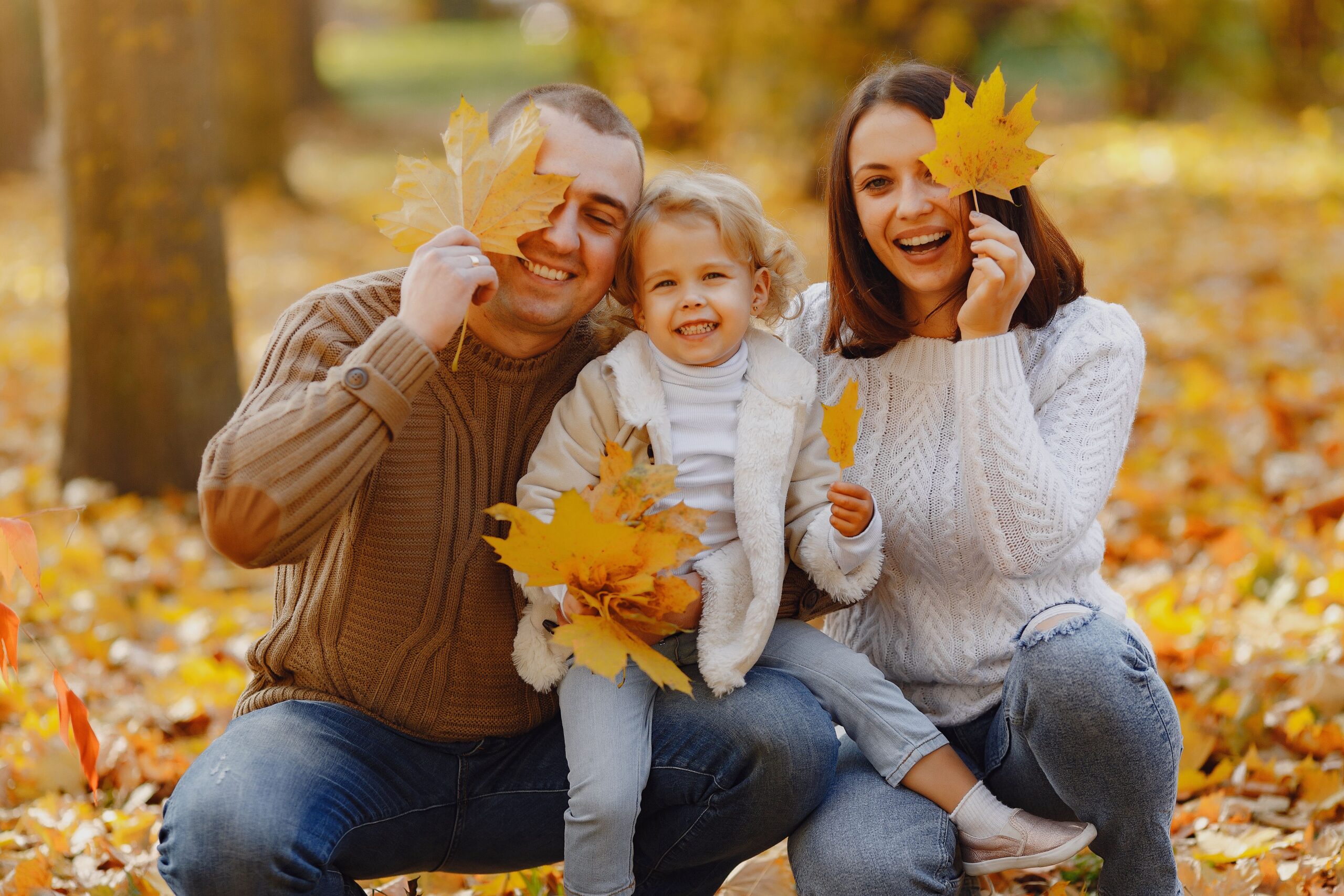 Family in a park during the fall in Woburn