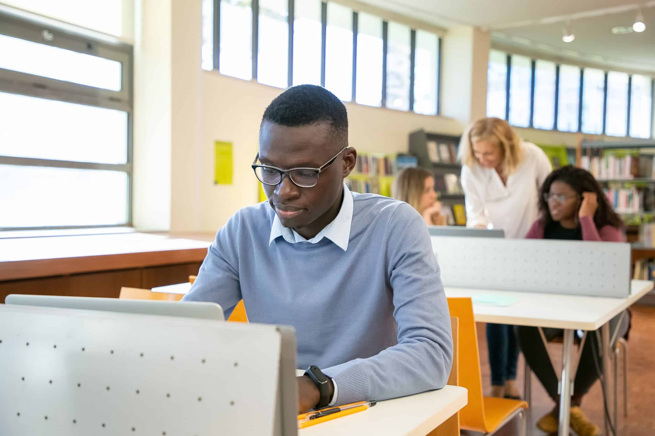 Mature student in a blue sweatshirt at a desk.