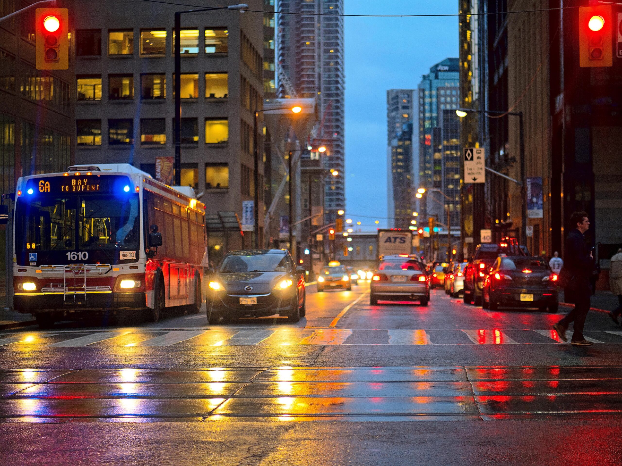 Traffic on a Toronto street at dusk.