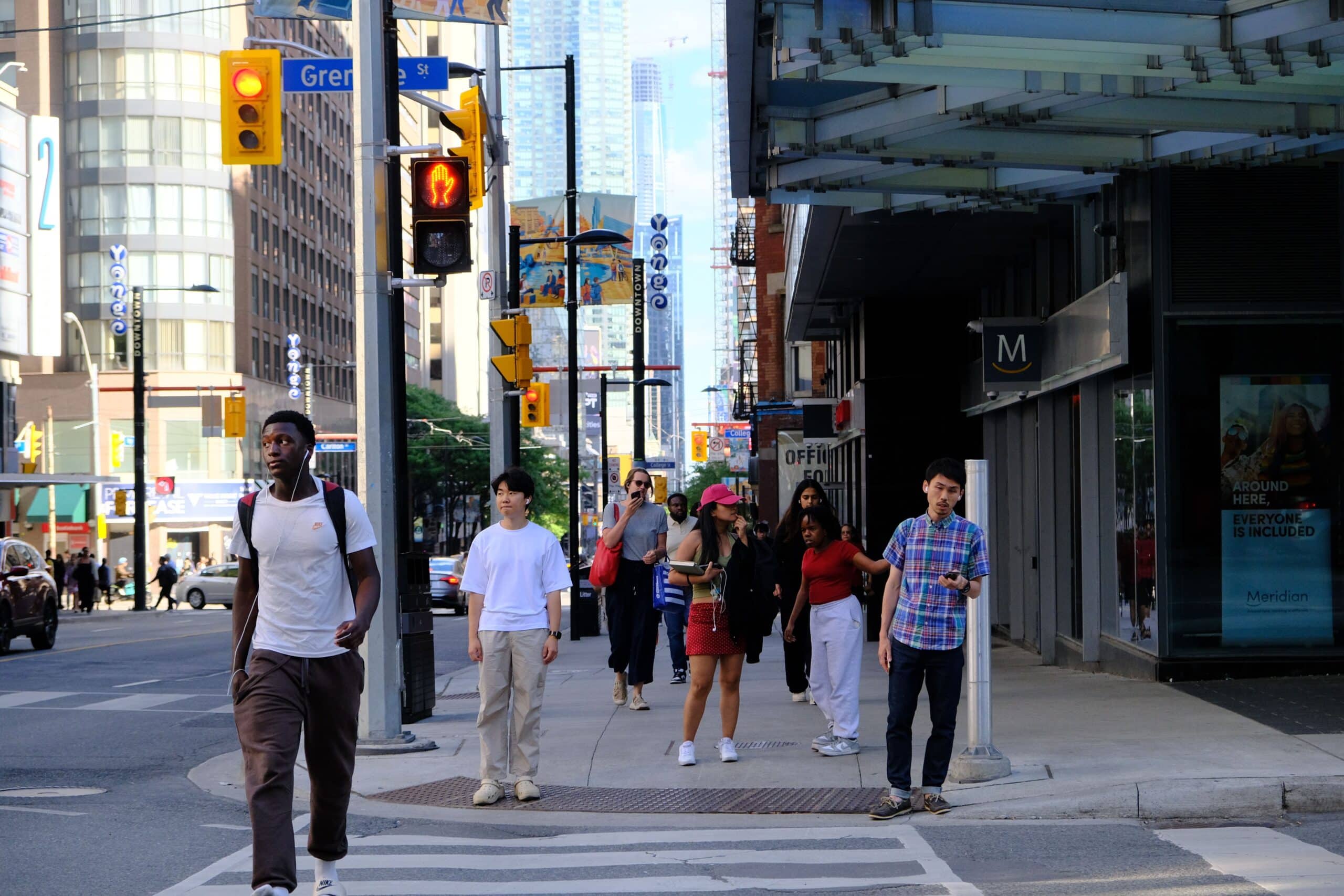 People walking at a crosswalk in Toronto.