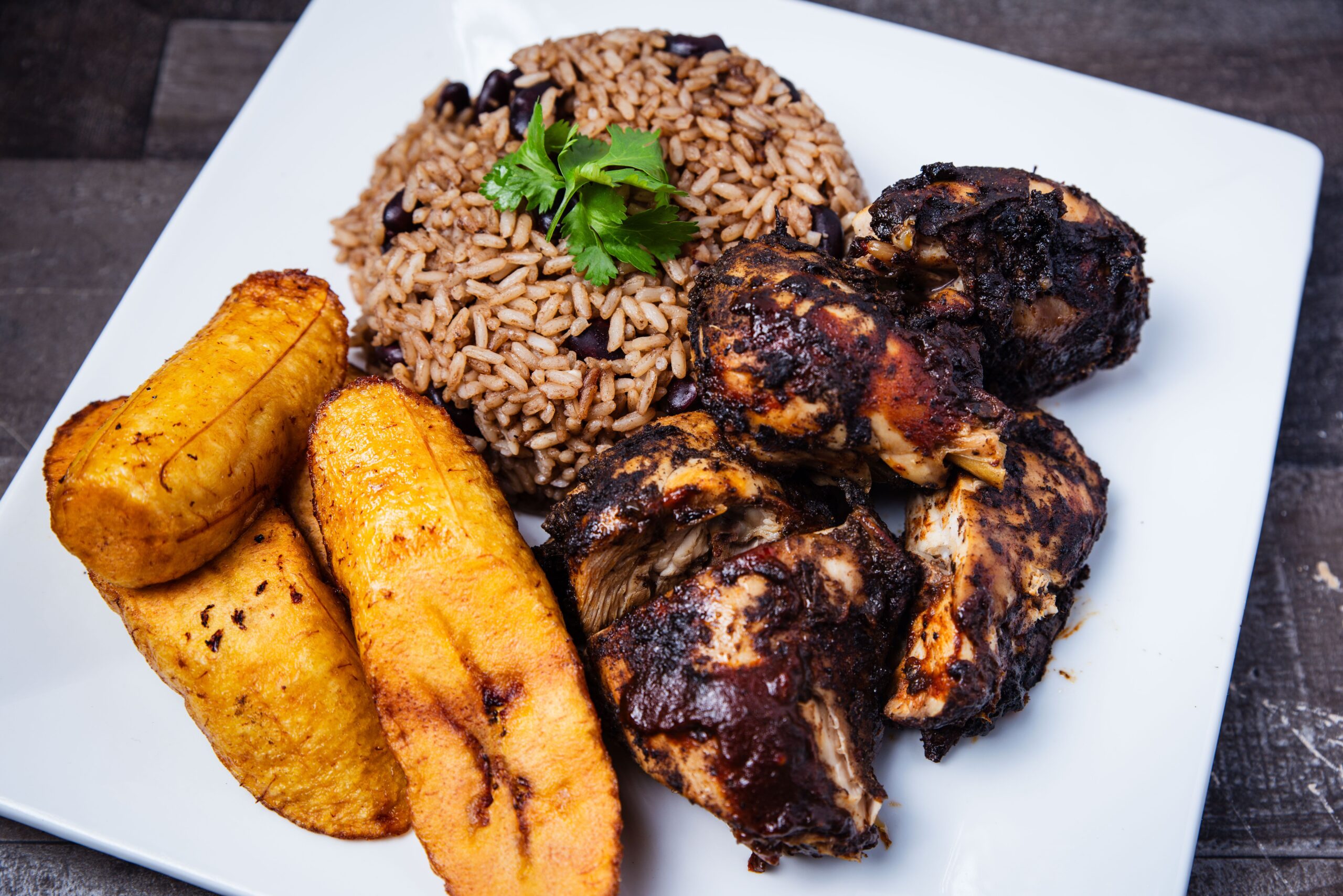 Jamaican food on a white plate.
